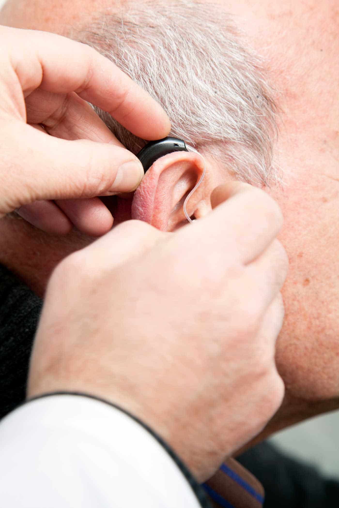man getting hearing aid fitted