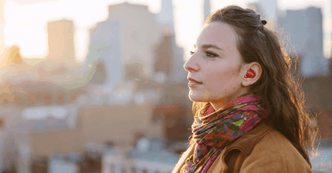 Woman with hearing device looking into the distance