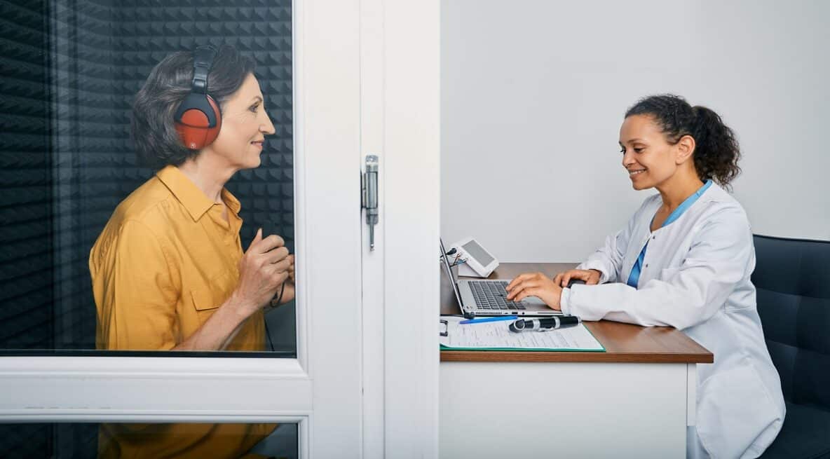 woman getting a hearing test conducted by audiologist
